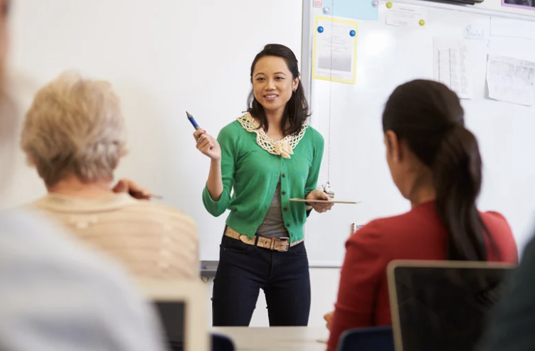 Woman in a green sweater teaching a workshop